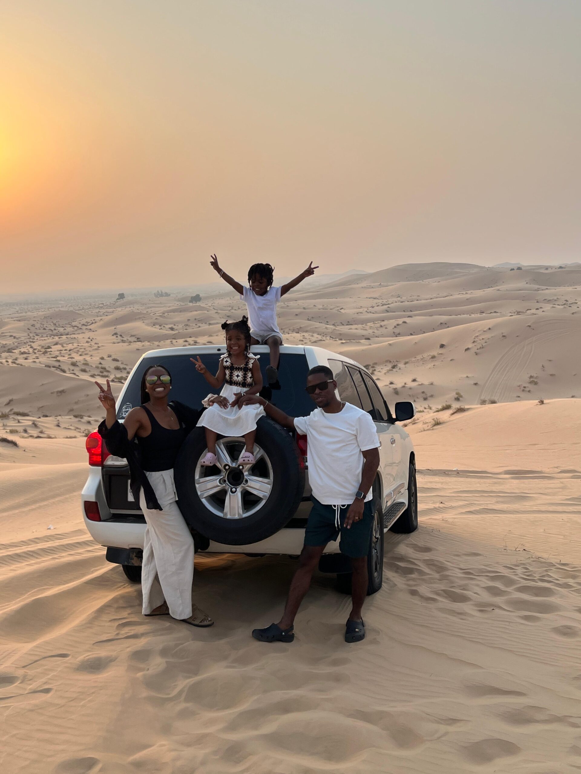 Exciting dune bashing in Dubai with a 4x4 vehicle climbing a steep red sand dune